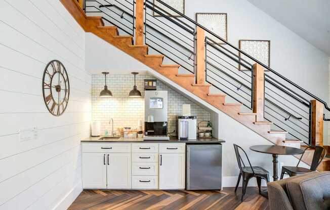 A kitchen with a staircase leading to the upper floor.