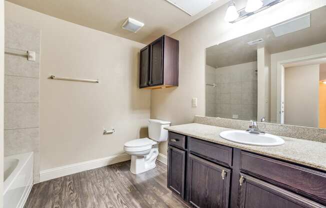 an empty bathroom with a toilet sink and mirror
