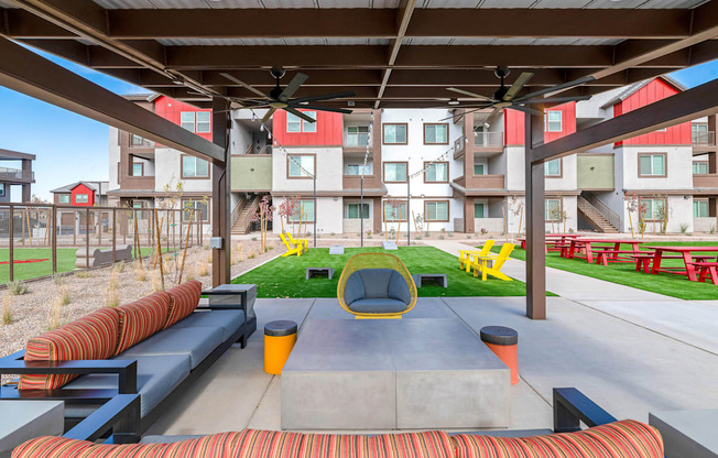 A modern outdoor seating area with a concrete table and chairs.