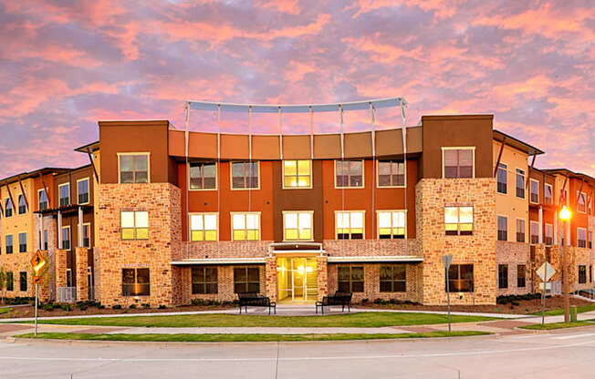 a building at sunset with the sky in the background