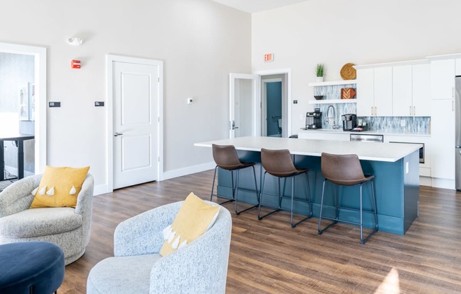 a picture of the club house at the sto in stoughton with a kitchen island and seating