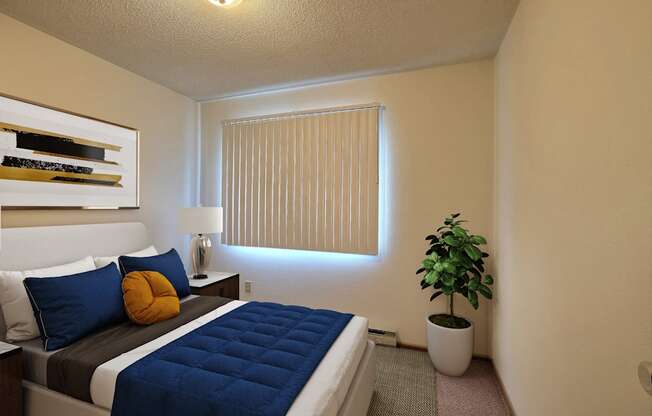 a bedroom with a large bed and a potted plant. Fargo, ND Pacific South Apartments