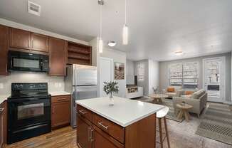 A modern kitchen with dark wood cabinets and a white island.
