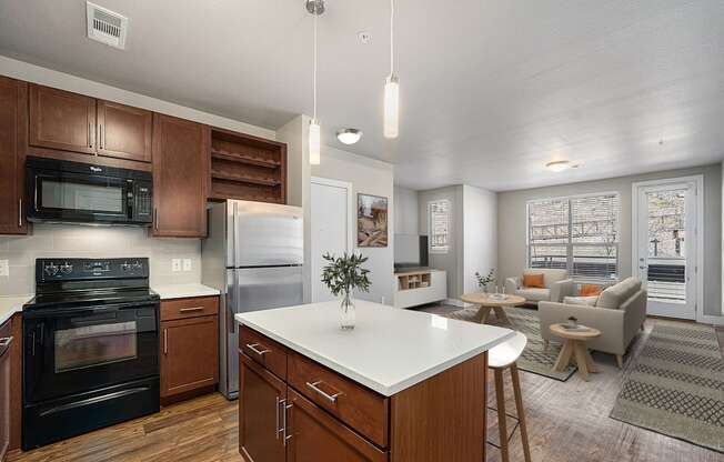 A modern kitchen with dark wood cabinets and a white island.