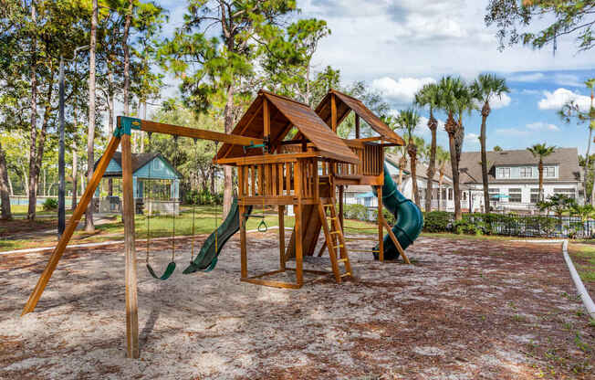 Community wooden playground with swings and slides at Mirage on Kernan in Jacksonville, Florida.