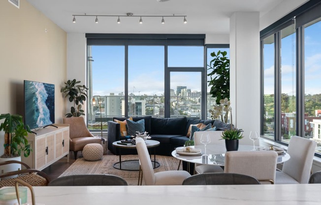 a living room with a large window and a view of a city at Stanza Little Italy, California, 92101