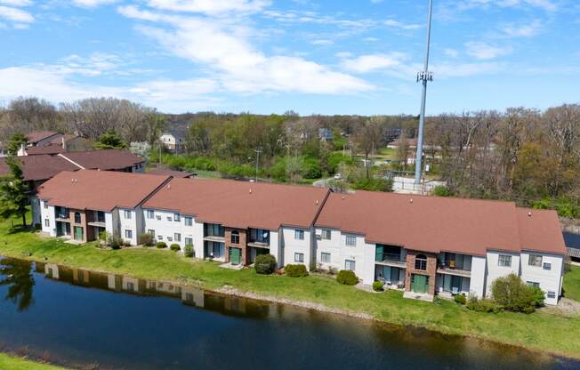 an aerial view of a building next to a river