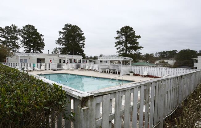 a pool with a white fence around it