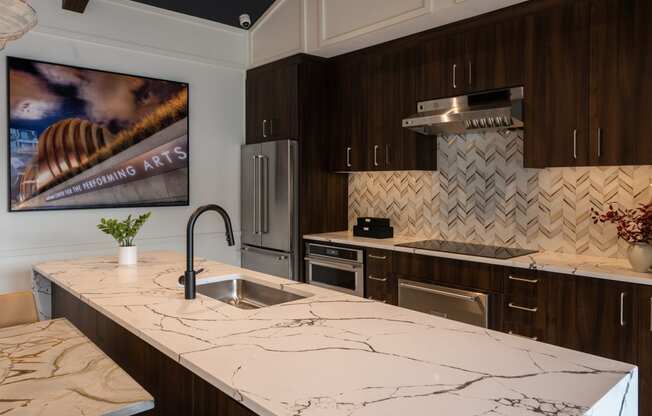 a kitchen with marble counter tops and a sink  at The Clearing at ONE28, Kansas, 66062