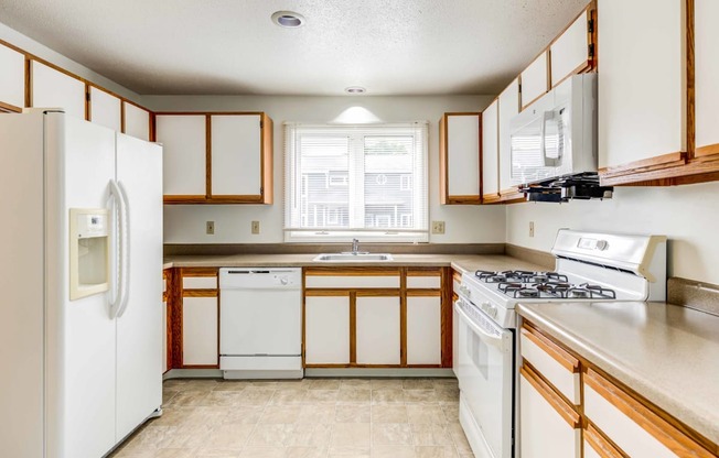 large kitchen with white appliances