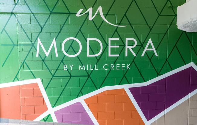 Vibrant, modern, and unmistakably Modera—our branded garage mural sets the tone the moment you arrive.