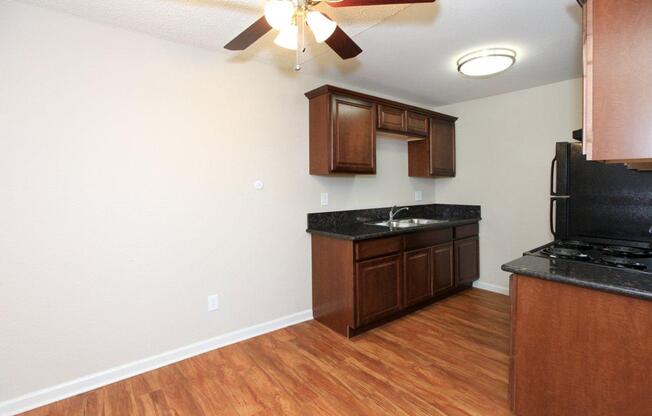 a large kitchen with stainless steel appliances and wooden cabinets