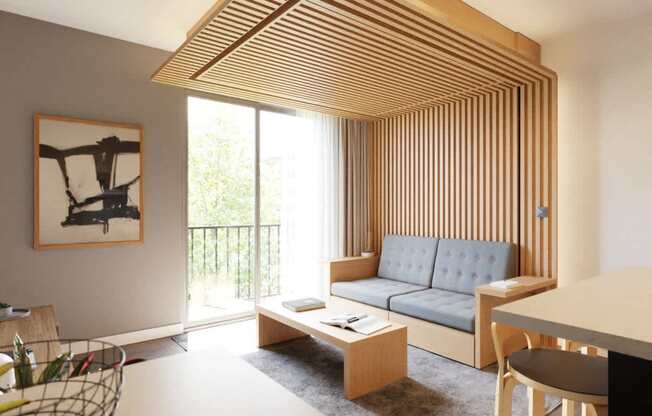 A living room with a grey couch and a painting of a horse on the wall.