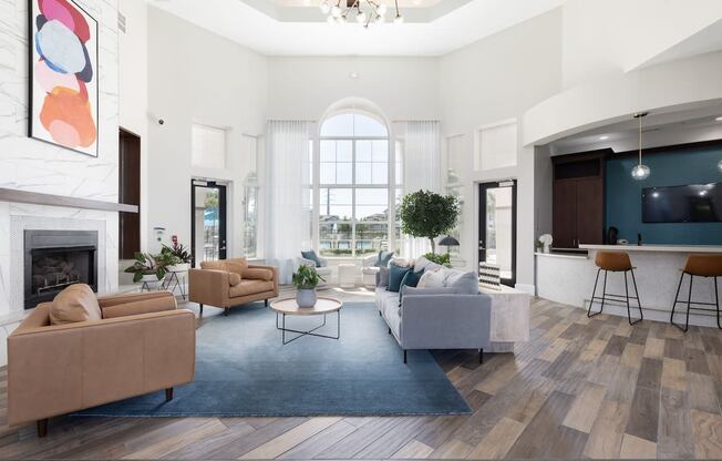 a living room with couches and chairs and a fireplace
