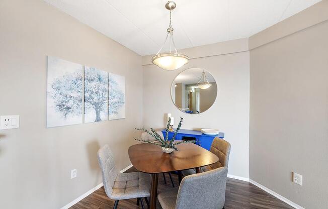 a dining room with a table and chairs at Troy Place Apartments - Troy, MI, Troy