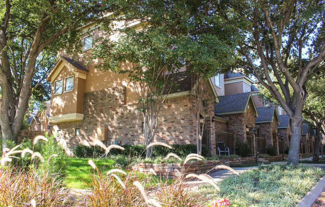 This is a photo of some Townhome exteriors at The Brownstones Townhome Apartments in Dallas, TX.