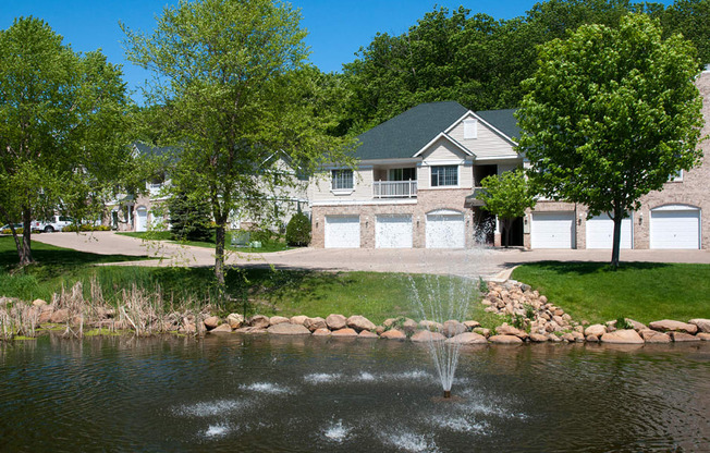 Townhome overlooking a lake with a fountain in it