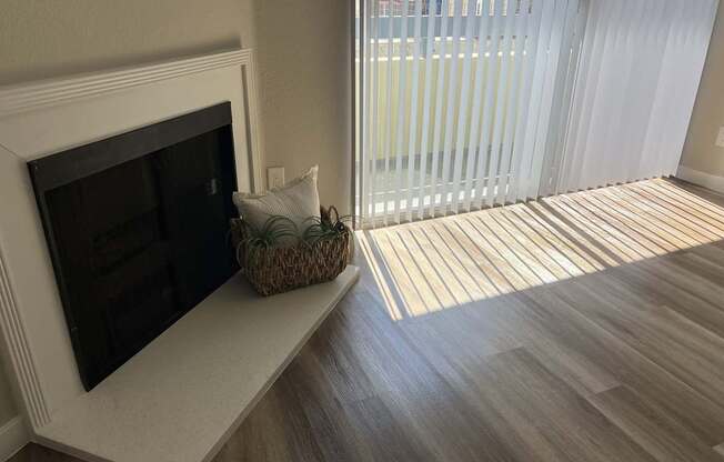 a living room with a fireplace and a sliding glass door