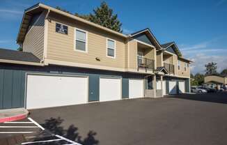 a large yellow house with a garage and a driveway