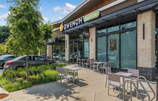 a patio outside of a restaurant with tables and chairs