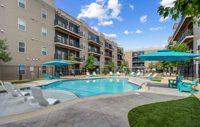 swimming pool with umbrellas at The Vue Luxury apartments in Indianapolis, IN