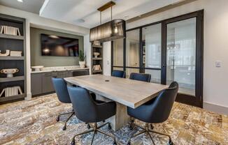A modern dining room with a wooden table and chairs.