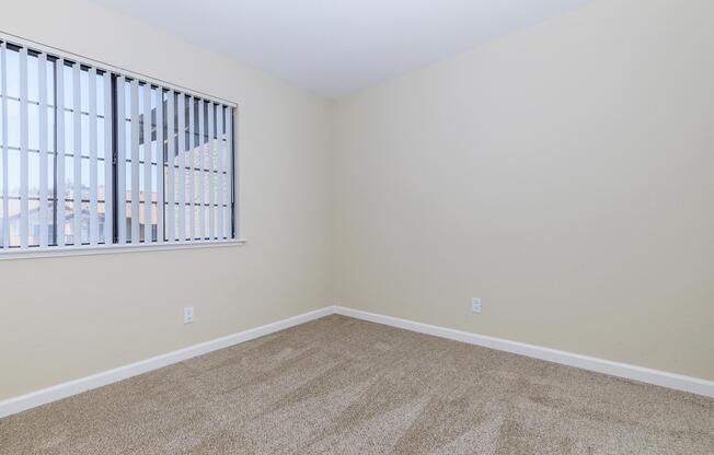 a bedroom with a large window