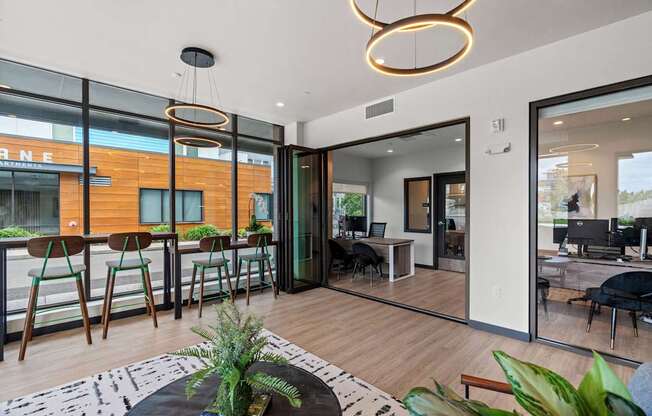 A modern living room with a bar area and a view of the street outside.