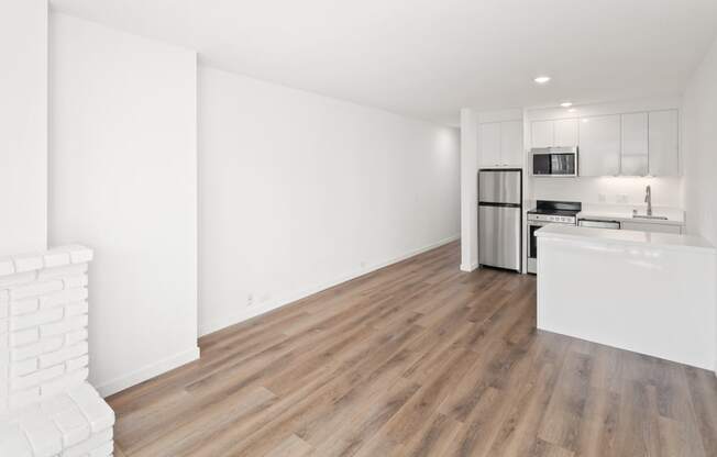 a bedroom with a medium sized bed and a kitchen with a stove and refrigerator