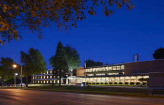 a large brick building with trees in front of it