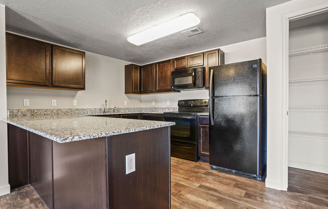 a kitchen with a counter top and a refrigerator