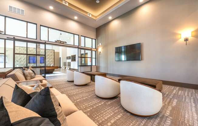 a living room with couches and chairs and a television