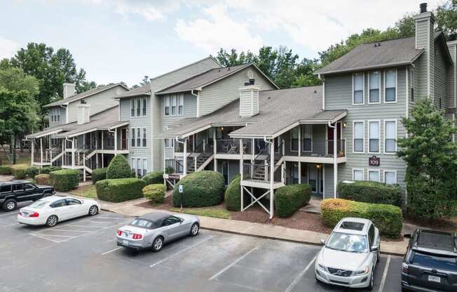 the apartment building with cars parked in front of it