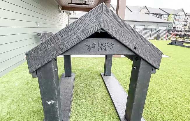 a dog house with a sign that says dogs only at The Depot, Raymore, MO