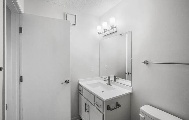 an empty bathroom with a sink and a mirror