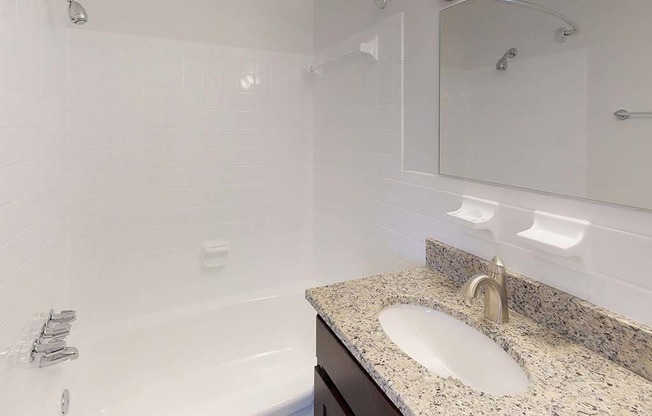 Granite counters in bathroom with sink at Gainsborough Court Apartments, Virginia