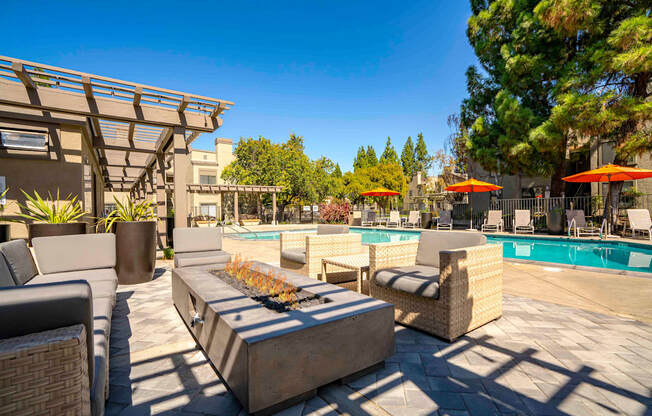 Apartments for Rent Walnut Creek, CA - Park Lake at Walnut Creek - Outdoor Lounge with Comfortable Seating, a Fire Table, by the Pool with Beautiful Landscaping