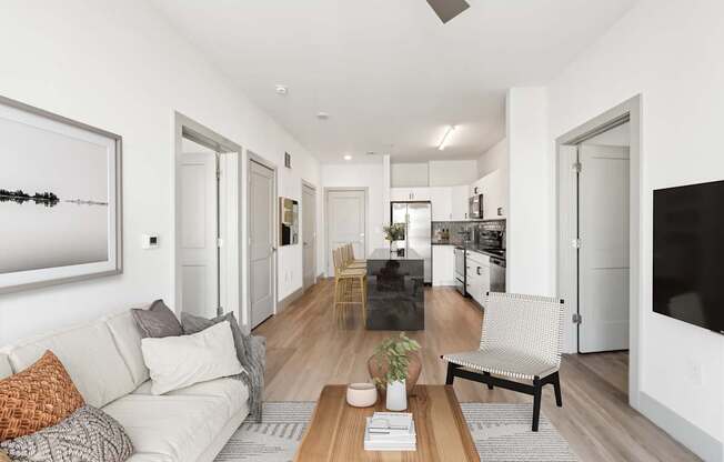 A modern living room with a white couch and a wooden coffee table.