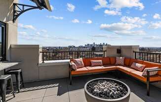 a rooftop patio with a couch and a fire pit at Alton Jefferson Park, Colorado, 80211