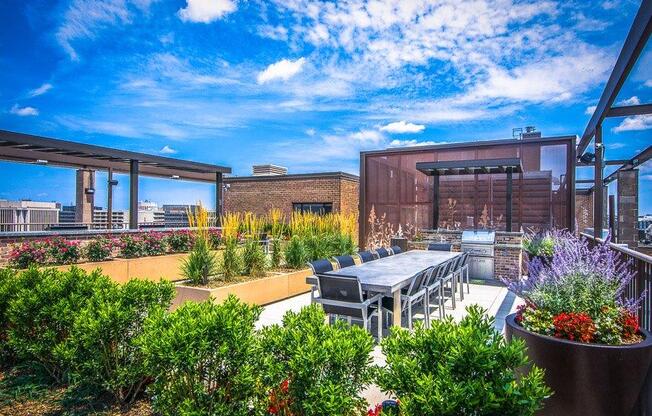 A patio with a table and chairs overlooks a cityscape.