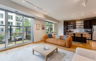 a living room with a couch and a coffee table in front of a large window