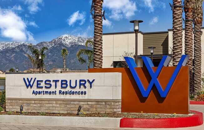 a sign for westbury apartment buildings with mountains in the backgroundat Westbury Apartments, Rancho Cucamonga, CA, 91739