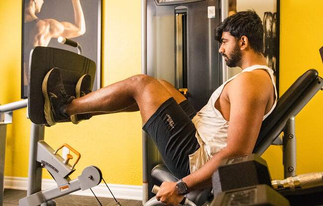 a man working out on a reformer exercise machine in a gym