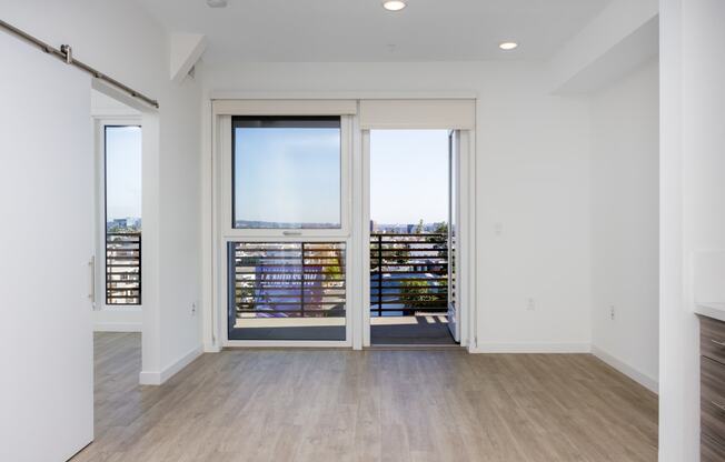 a living room with glass doors and a balcony