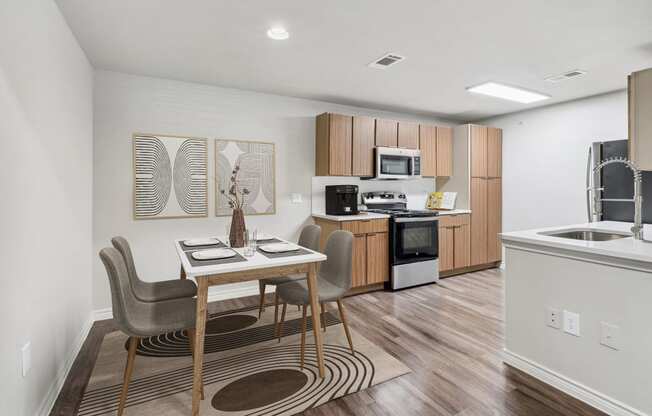 a kitchen and dining room with a table and chairs