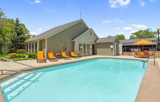 a swimming pool with a house in the background
