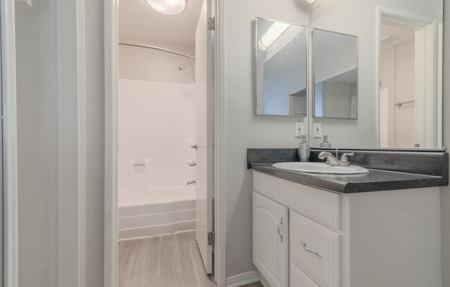 a bathroom with a sink and a mirror at City View Apartments at Warner Center, California, 91367
