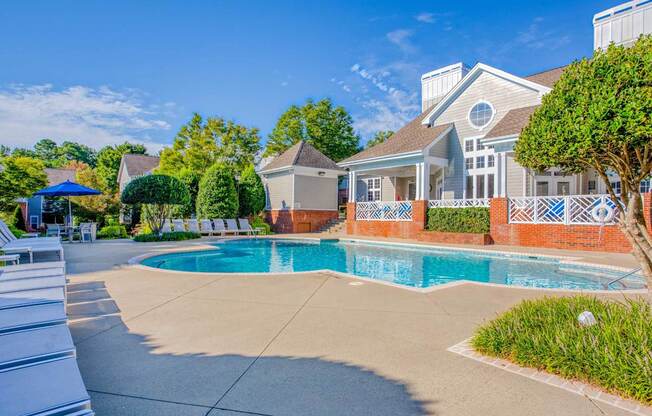 A house with a pool in front of it.