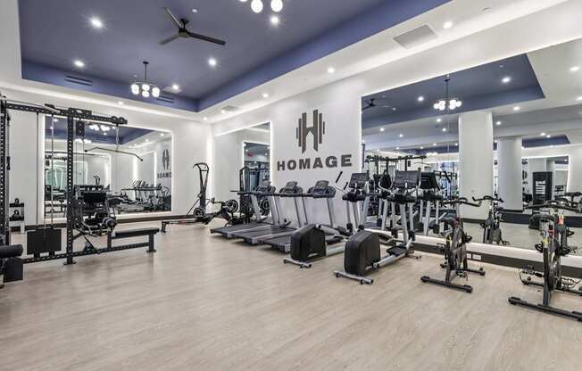A gym with a variety of equipment including treadmills, weights, and exercise bikes.