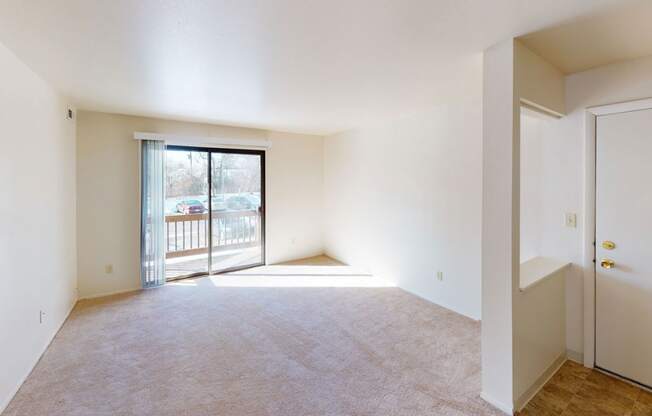 entry and living room with a sliding glass door to a balcony